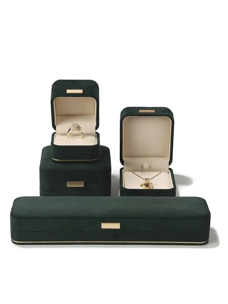 Suede ring, pendant and long chain boxes in dark green and carmine