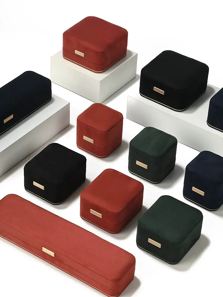 Premium suede boxes in carmine, black, dark green and dark blue