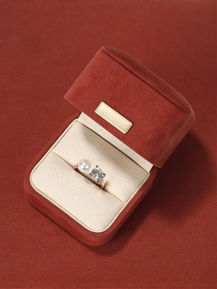 Carmine suede ring box open with a ring